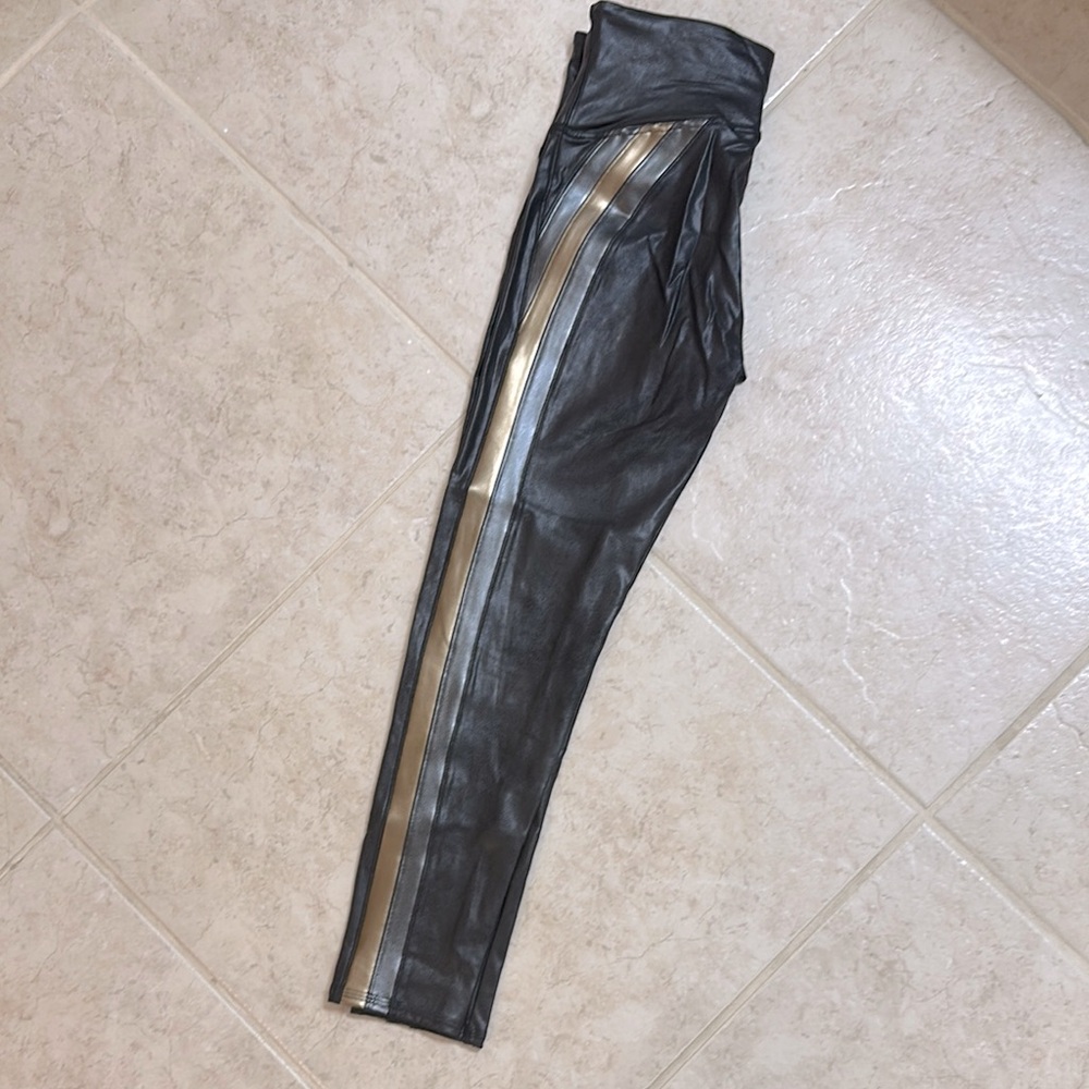 NWOT. SPANX metallic Black faux leather Leggings with Gold and silver Stripe.